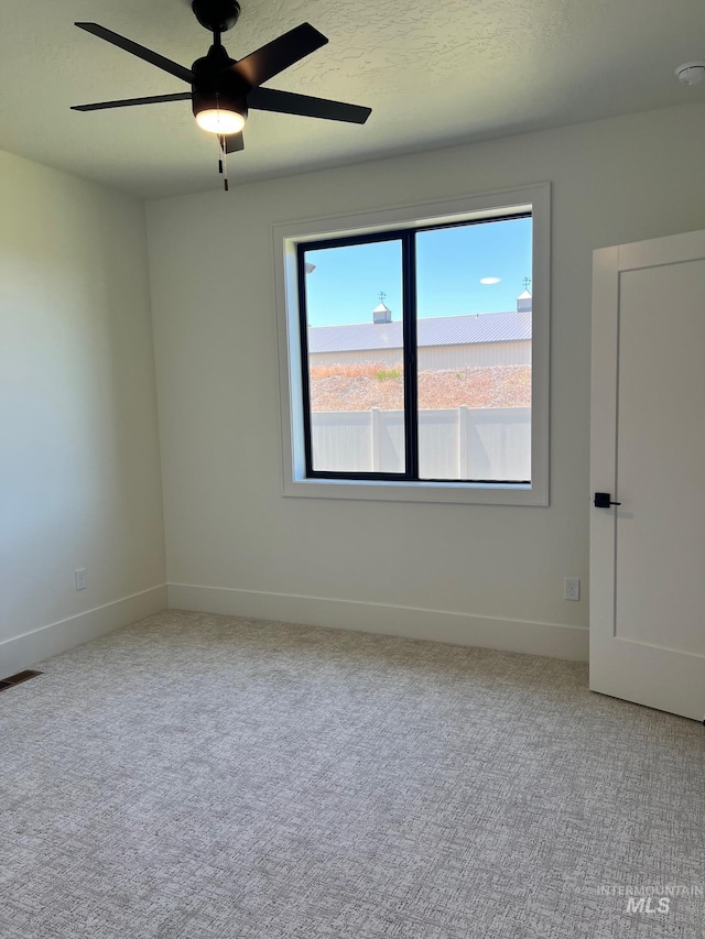 3075 N Costa Madera Ave, Star, ID 83669 - spare room featuring baseboards, carpet, and ceiling fan