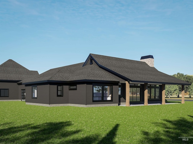 back of house with a yard, a chimney, and a shingled roof