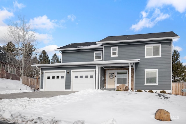 traditional-style home with an attached garage and fence