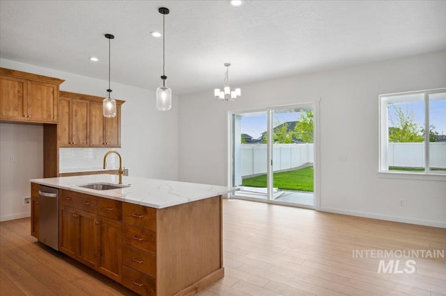 5351 W Mcnair St, Meridian, ID 83646 - kitchen featuring a sink, dishwasher, light wood-style floors, brown cabinetry, and hanging light fixtures