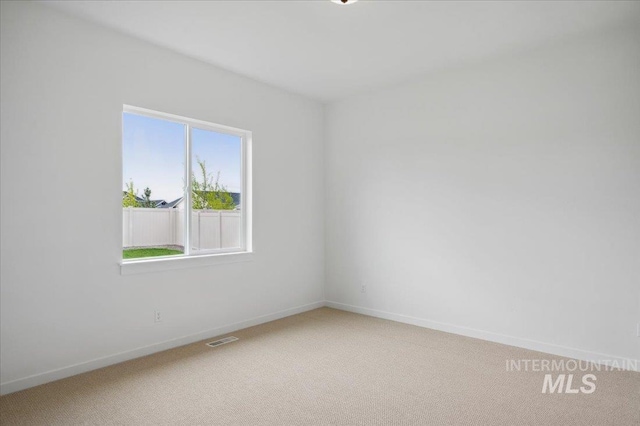 5351 W Mcnair St, Meridian, ID 83646 - unfurnished room with light carpet and baseboards