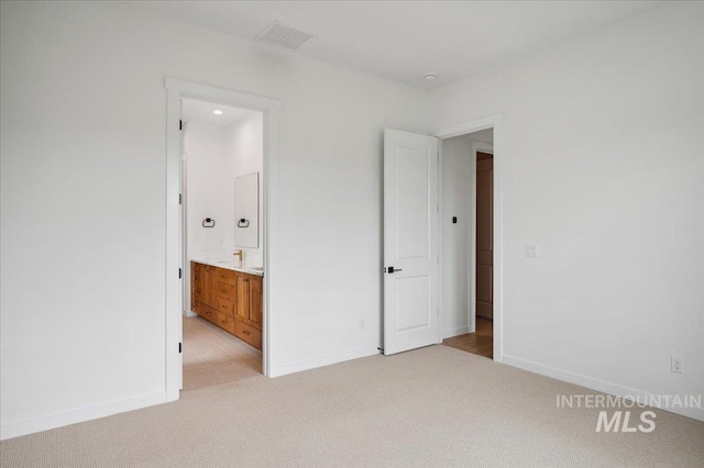 5351 W Mcnair St, Meridian, ID 83646 - unfurnished bedroom with light carpet, baseboards, and ensuite bath