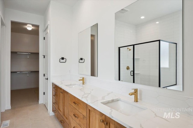 5351 W Mcnair St, Meridian, ID 83646 - full bathroom with double vanity, a shower stall, and a walk in closet