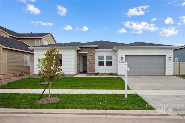 5351 W Mcnair St, Meridian, ID 83646 - view of front facade with an attached garage, concrete driveway, and stone siding
