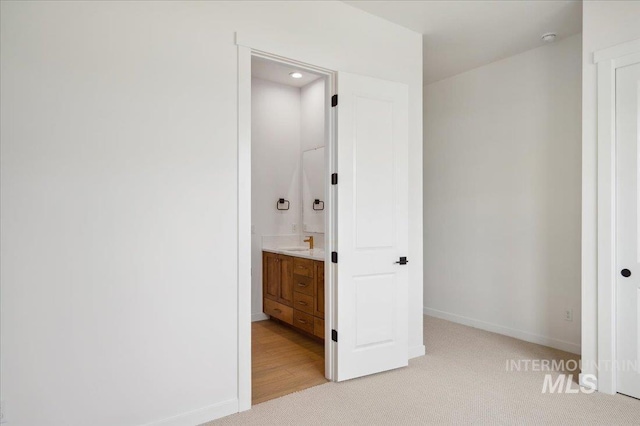 5351 W Mcnair St, Meridian, ID 83646 - unfurnished bedroom featuring baseboards, light carpet, a sink, connected bathroom, and recessed lighting