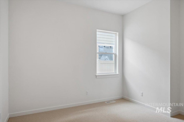 5351 W Mcnair St, Meridian, ID 83646 - spare room featuring light carpet, healthy amount of natural light, and baseboards
