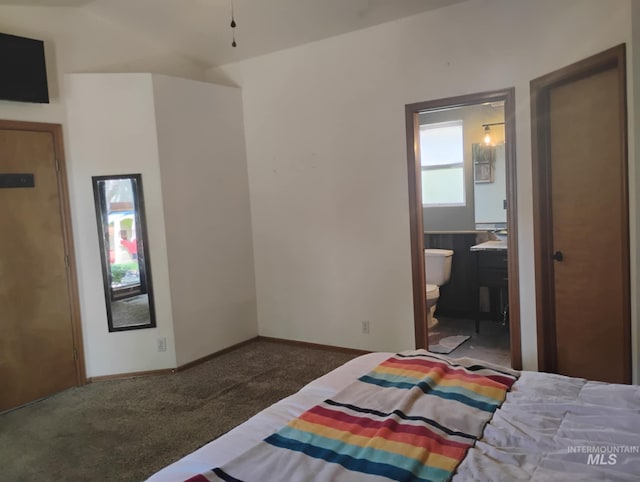 bedroom featuring carpet, baseboards, and ensuite bath
