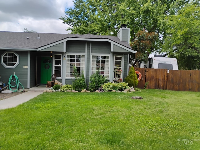 view of front of home with a chimney and a shingled roof