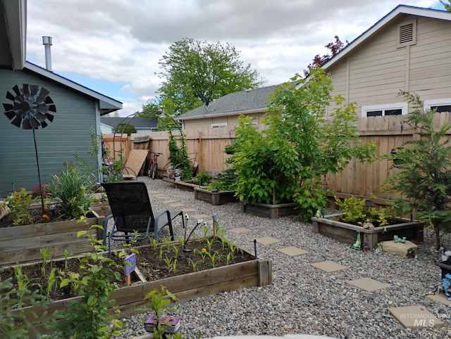 view of yard featuring a vegetable garden and fence