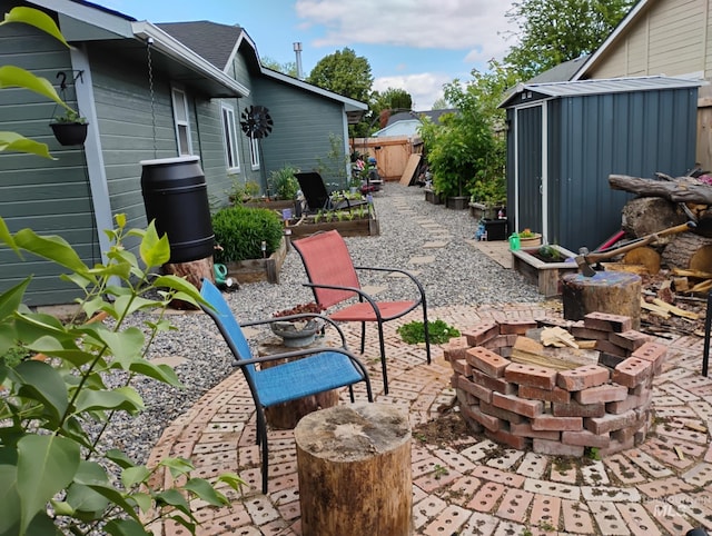view of patio with an outdoor fire pit and fence