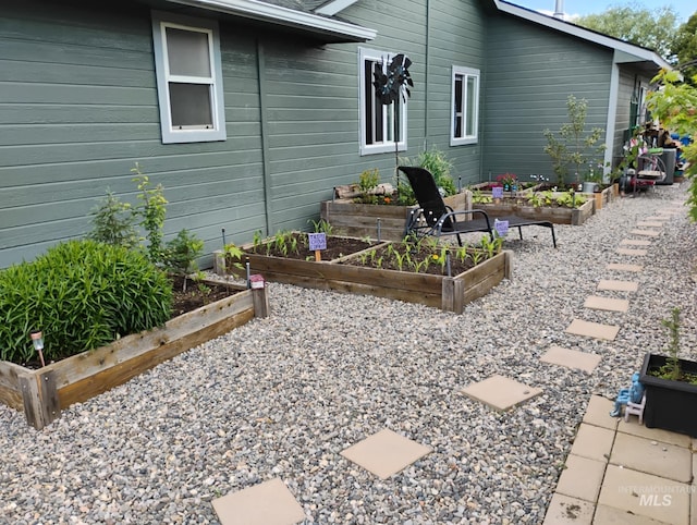 view of side of property with a garden
