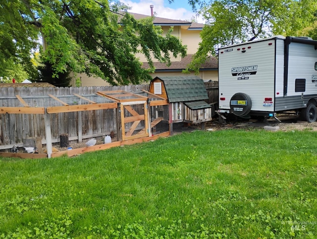 view of yard with exterior structure and an outbuilding