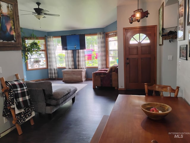 entryway with healthy amount of natural light, a ceiling fan, wood finished floors, and vaulted ceiling