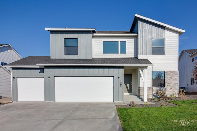 view of front facade featuring board and batten siding, concrete driveway, a front yard, and a shingled roof