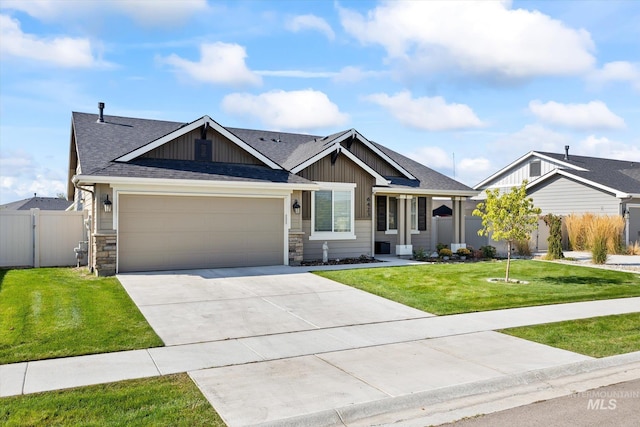 craftsman inspired home with a garage and a front lawn