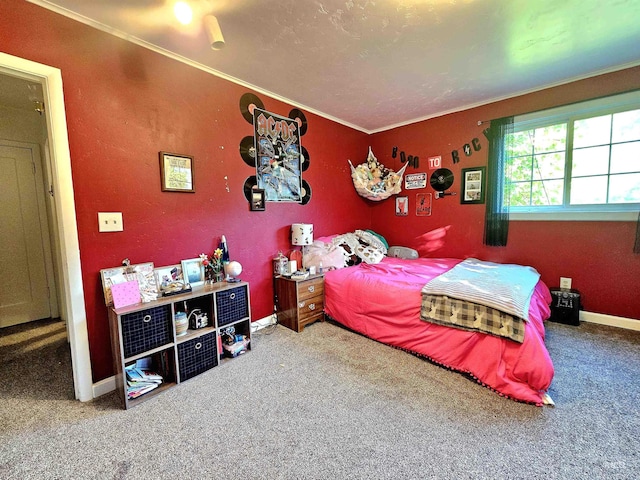 carpeted bedroom featuring ornamental molding and baseboards