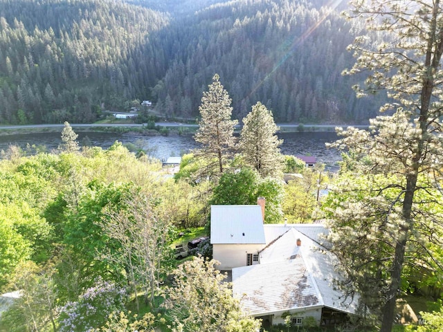 drone / aerial view featuring a water view and a view of trees
