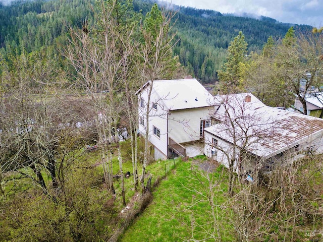 birds eye view of property with a forest view