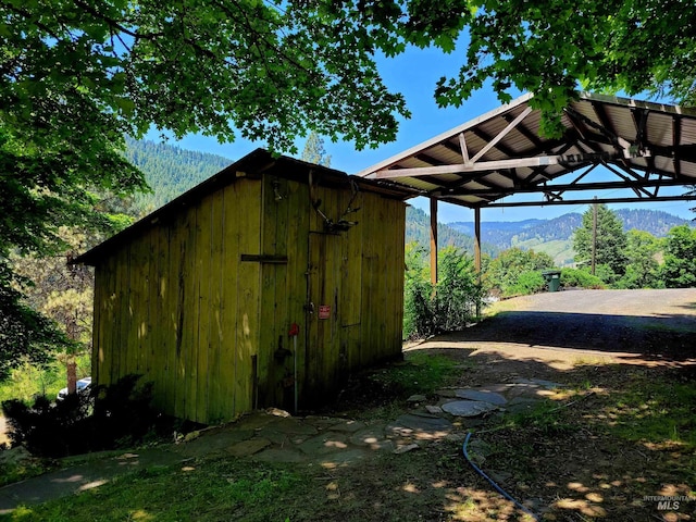 view of shed featuring a detached carport and a mountain view