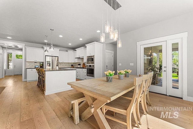 dining space featuring recessed lighting and light wood-style floors