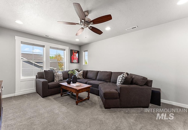 carpeted living area featuring recessed lighting, a ceiling fan, visible vents, and baseboards