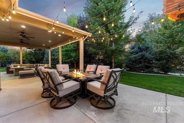 view of patio / terrace with an outdoor living space with a fire pit and ceiling fan
