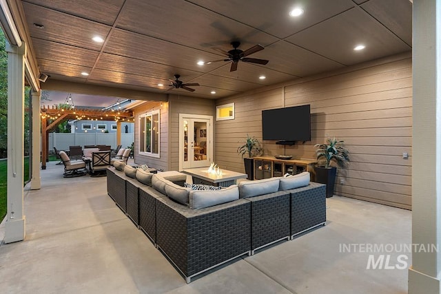 living room with wooden walls, ceiling fan, and finished concrete floors