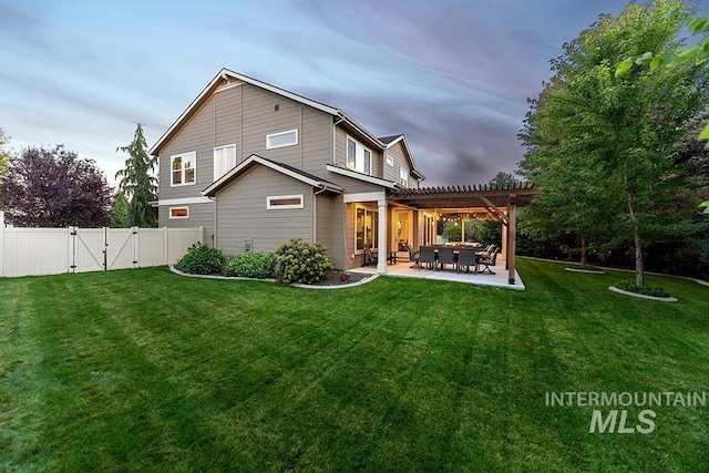 back of property featuring a lawn, a gate, a fenced backyard, a patio, and a pergola
