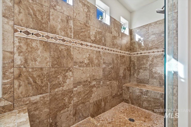 full bath with a tile shower