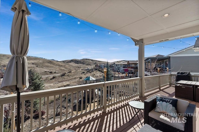 balcony with a deck with mountain view and a residential view