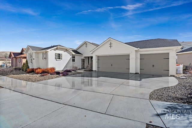 ranch-style home with central AC unit, a garage, driveway, and stucco siding