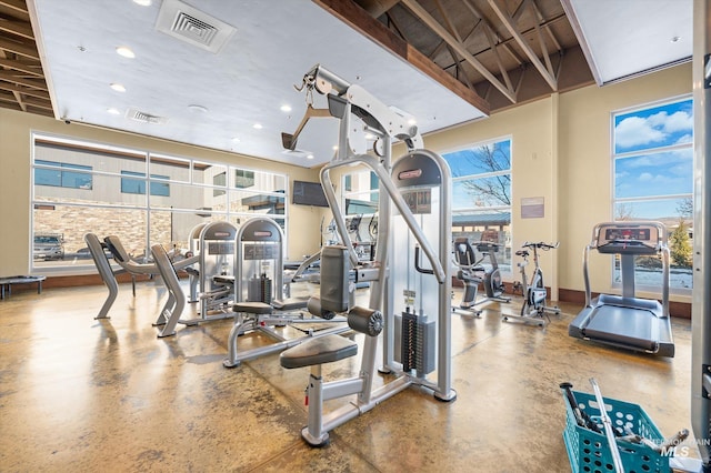 gym featuring recessed lighting, a healthy amount of sunlight, and visible vents