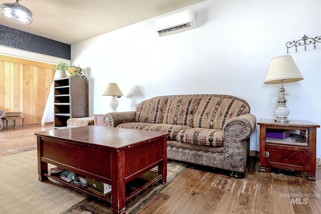 living room with dark wood finished floors and a wall mounted AC