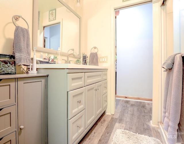 bathroom with vanity and wood finished floors