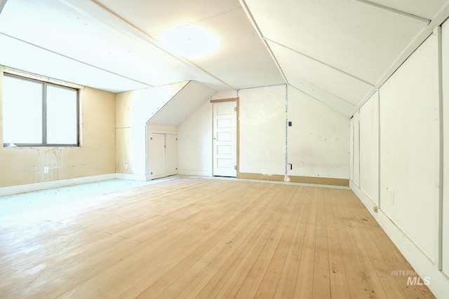 bonus room featuring light wood-type flooring and lofted ceiling