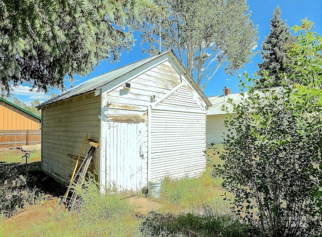 view of shed featuring fence