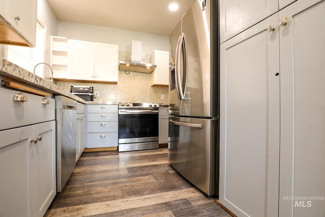 kitchen featuring appliances with stainless steel finishes, light countertops, wall chimney range hood, white cabinetry, and open shelves