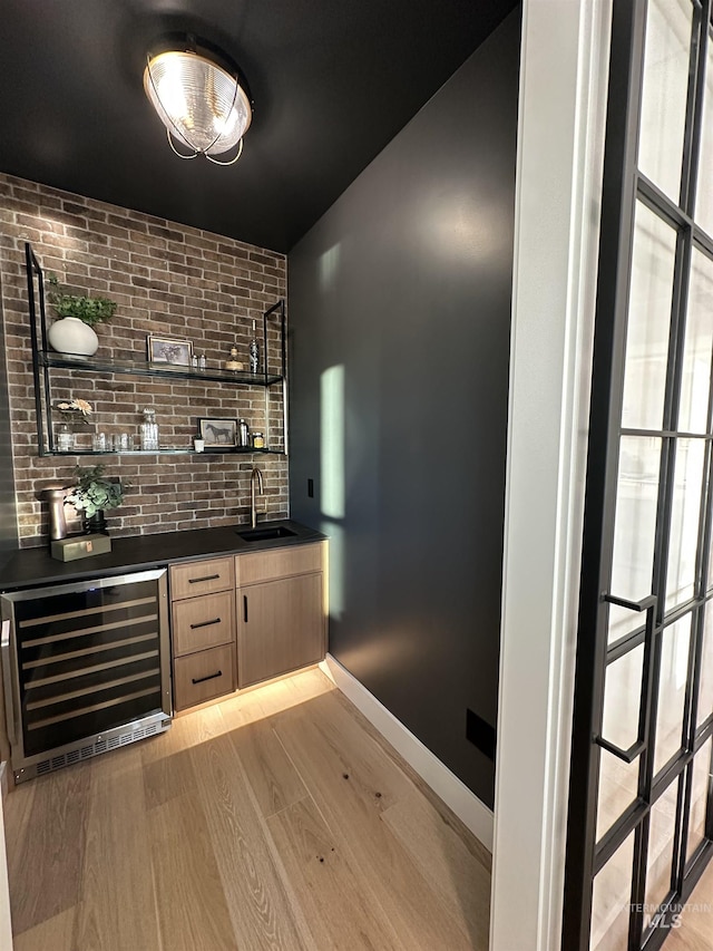 461 S Quincannon Ln, Star, ID 83669 - bar with a sink, light wood-style flooring, indoor wet bar, baseboards, and wine cooler