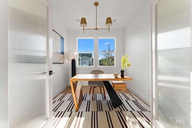 461 S Quincannon Ln, Star, ID 83669 - dining space with baseboards, wood finished floors, and a notable chandelier