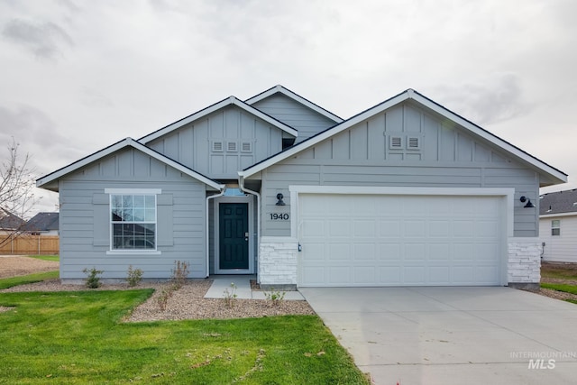 ranch-style home with a garage, driveway, a front lawn, and board and batten siding