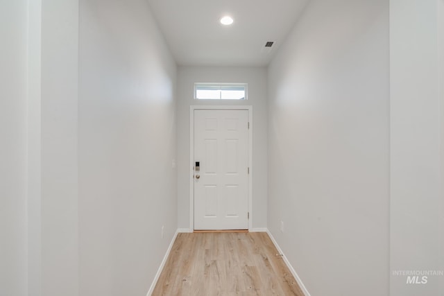 entryway featuring light wood-style floors, recessed lighting, and baseboards