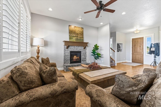 9968 Moon Shadow Ct, Middleton, ID 83644 - living area featuring stairway, recessed lighting, a ceiling fan, healthy amount of natural light, and a stone fireplace