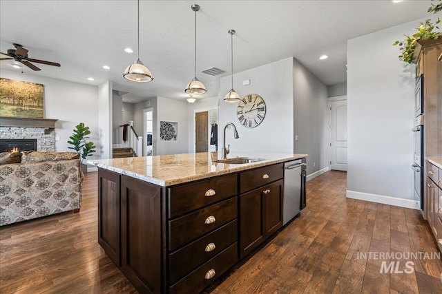9968 Moon Shadow Ct, Middleton, ID 83644 - kitchen with dishwasher, open floor plan, dark wood-type flooring, a kitchen island with sink, and dark brown cabinetry