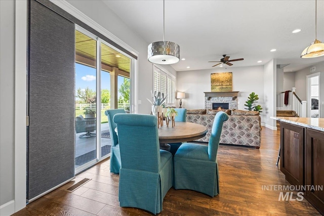 9968 Moon Shadow Ct, Middleton, ID 83644 - dining area featuring dark wood finished floors, ceiling fan, a fireplace, and recessed lighting