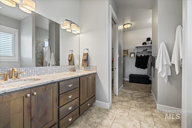 9968 Moon Shadow Ct, Middleton, ID 83644 - full bathroom with double vanity, backsplash, a spacious closet, a tile shower, and marble finish floors