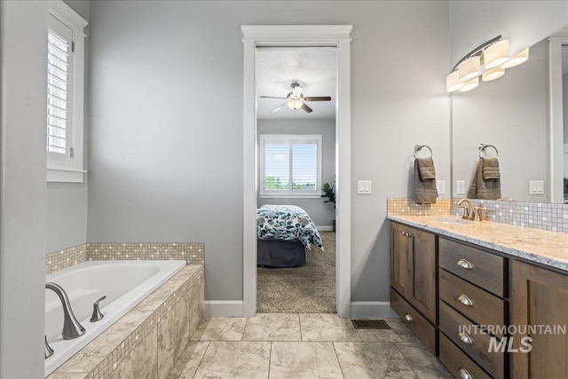 9968 Moon Shadow Ct, Middleton, ID 83644 - full bathroom with vanity, a garden tub, ensuite bath, a ceiling fan, and tasteful backsplash
