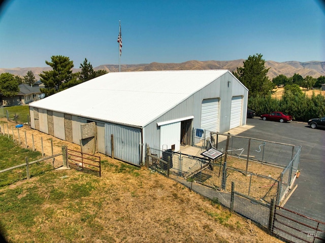 view of outdoor structure with a garage and a mountain view