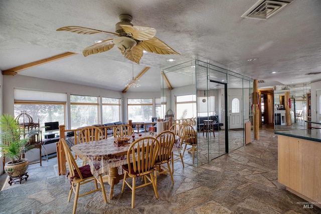 dining room with ceiling fan, a textured ceiling, and plenty of natural light