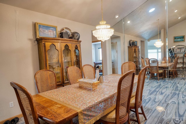 dining space featuring a chandelier and lofted ceiling