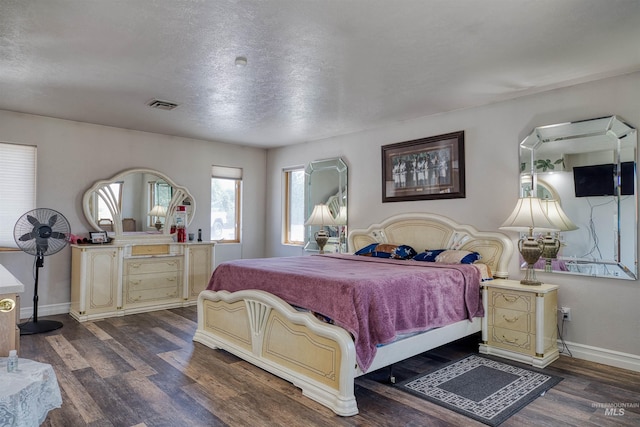 bedroom with dark hardwood / wood-style floors